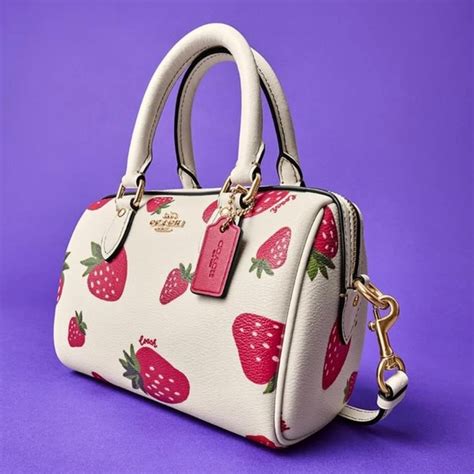 coach purse with strawberries.